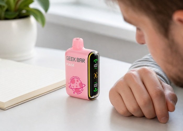 Adult checking the display on a pink Geek Bar Pulse