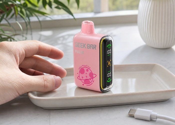 Pink Geek Bar Pulse cooling on a tray beside a disconnected USB-C cable