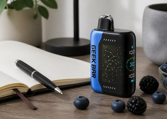 Geek Bar Pulse X Blackberry Blueberry beside a blank tasting notebook and mixed berries