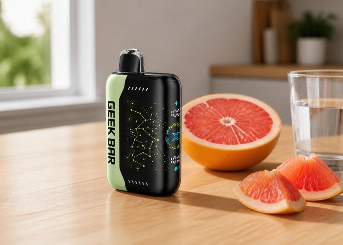 Geek Bar Pulse X Grapefruit Refresher beside grapefruit and water on an adult kitchen table