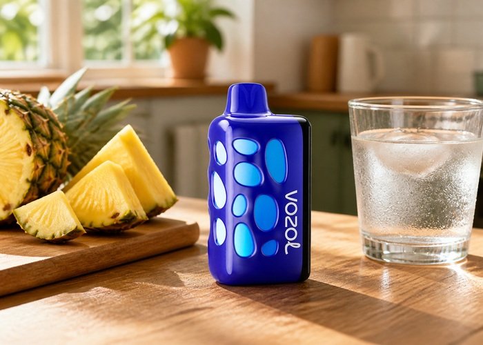 Blue VOZOL Rave 50K Hawaiian Pineapple Paradise beside fresh pineapple and ice water