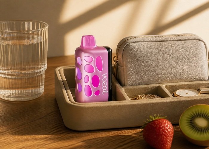 VOZOL Rave 50K Strawberry Kiwi stored upright beside a plain pouch and water