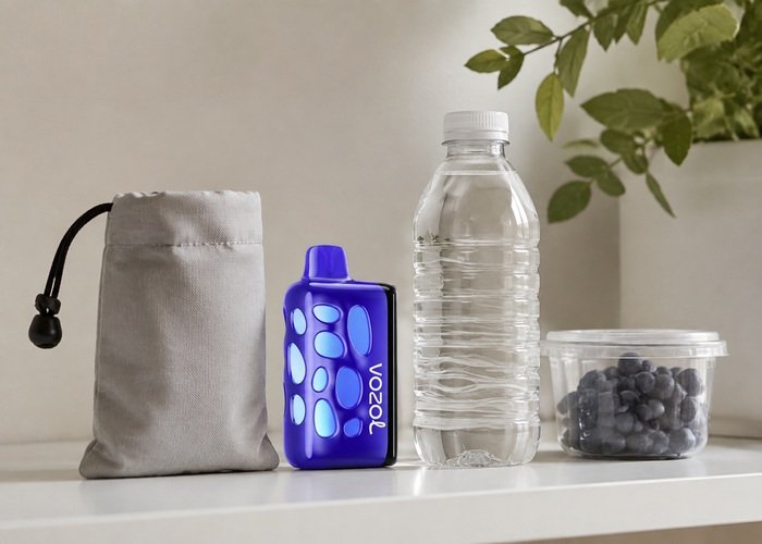 VOZOL Rave 50K Blueberry Watermelon stored upright beside a plain pouch and water